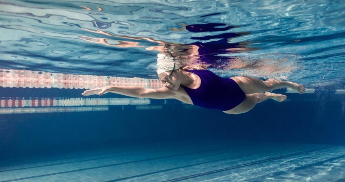 stock-photo-underwater-picture-female-swimmer-swimming-suit-goggles-training-swimming-pool